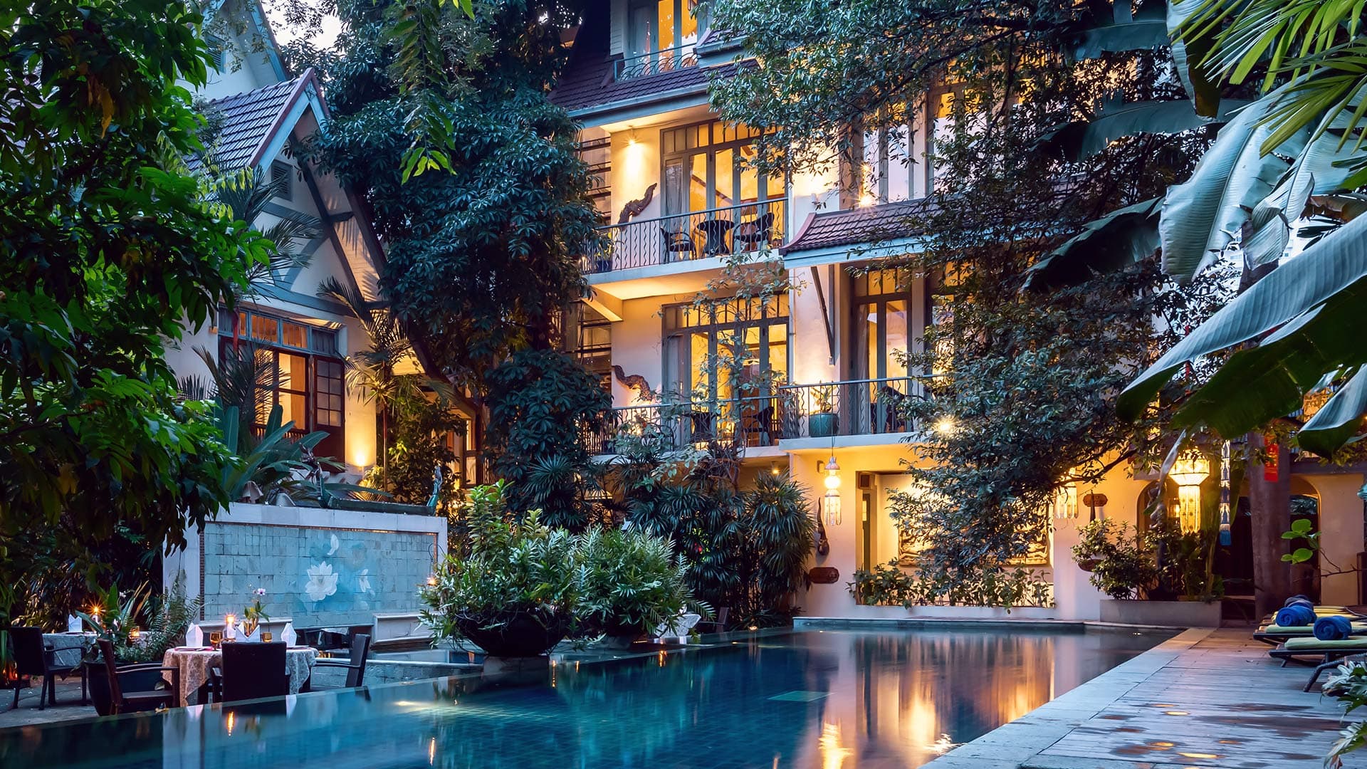 AriyasomVilla swimming pool and garden at dusk