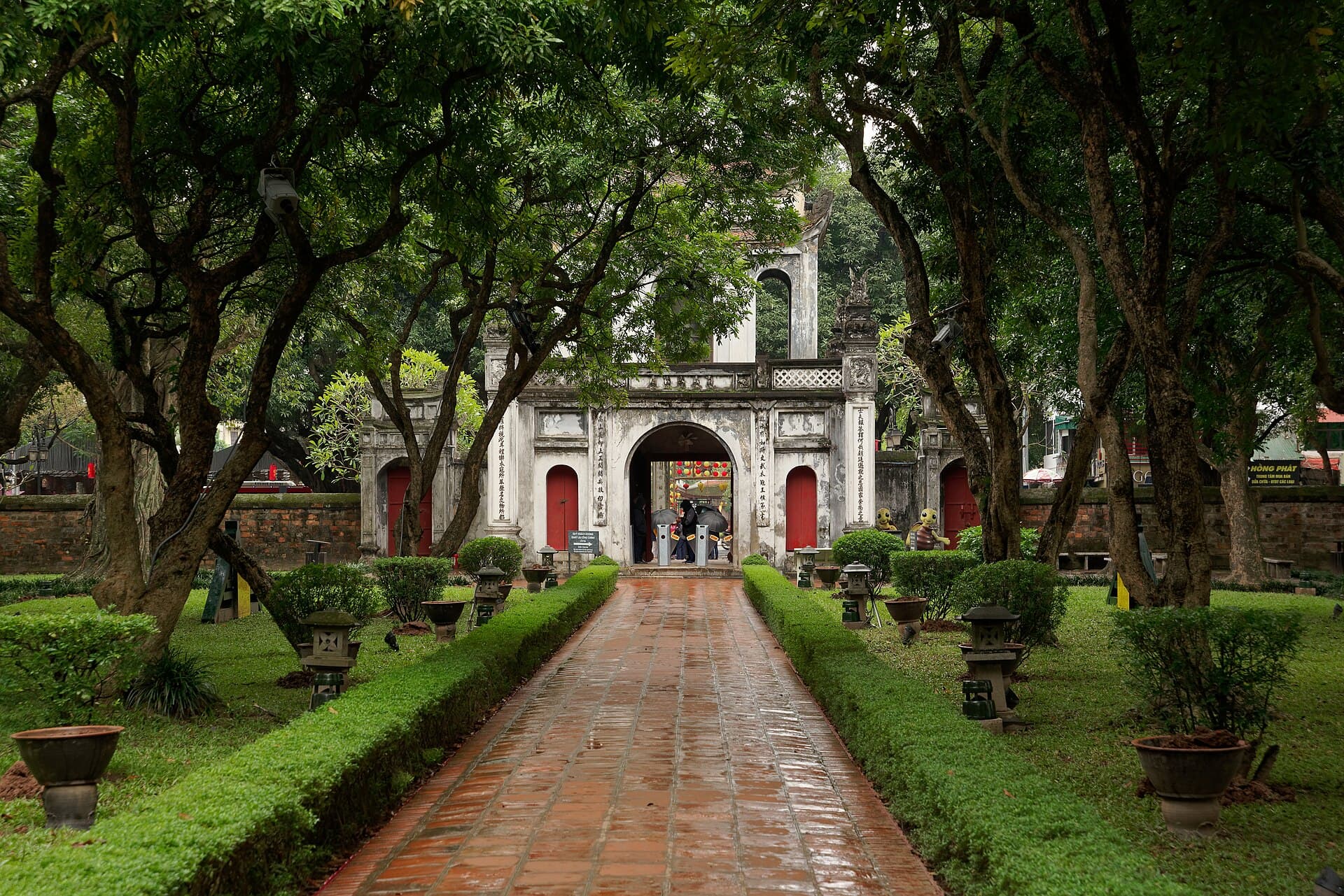 Temple of Literature gate framed by trees in Hanoi