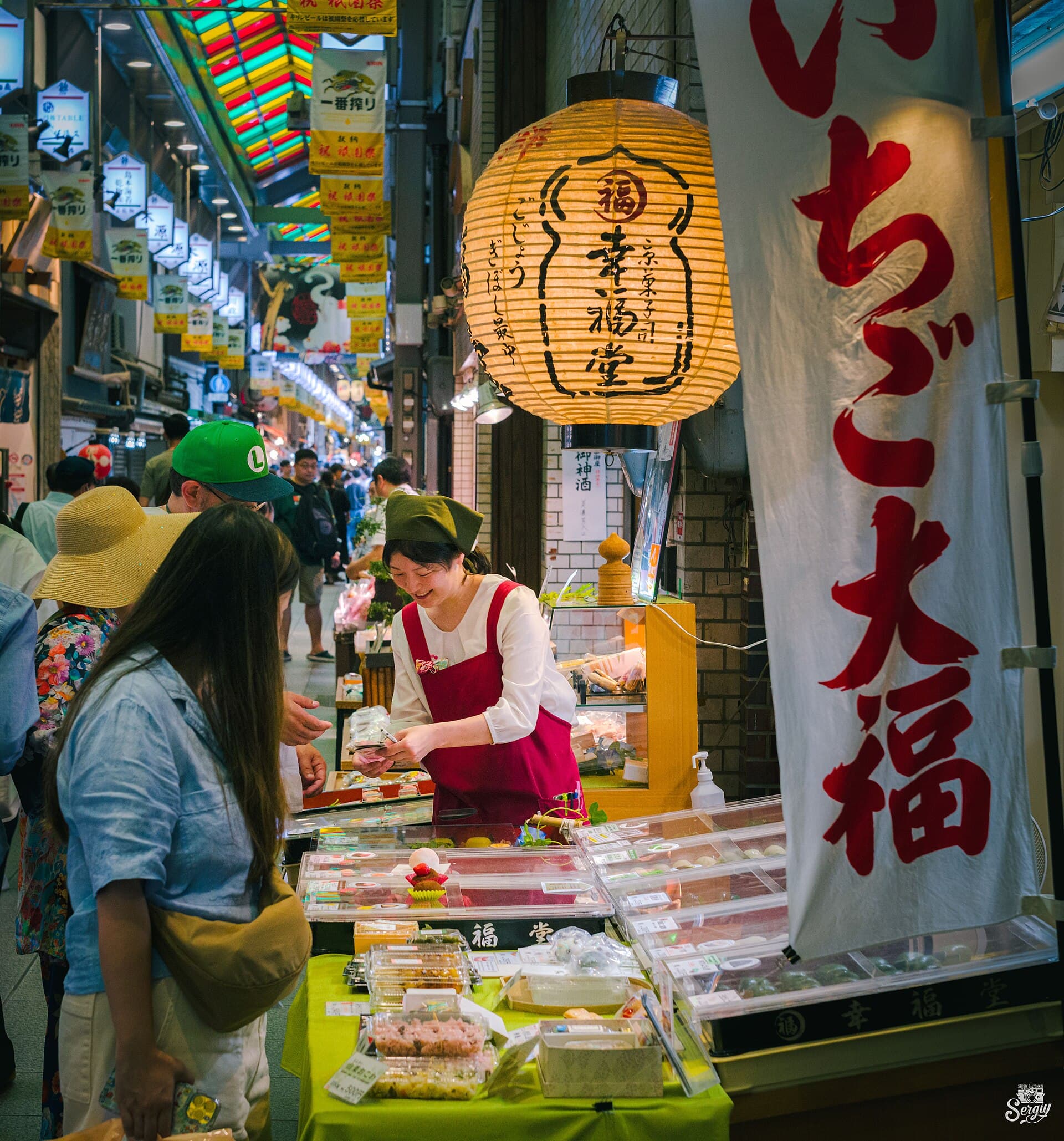 Shoppers beneath the covered arcade of Nishiki Market